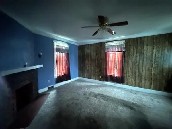 a big room with windows and ceiling fan