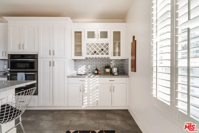 a kitchen with stainless steel appliances kitchen island granite countertop a refrigerator and a stove top oven