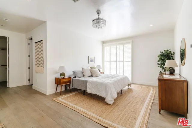 a bedroom with a bed and a table