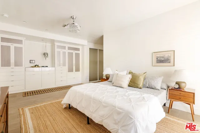 a bathroom with a granite countertop sink mirror and toilet