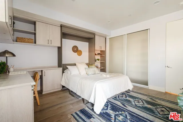 a bedroom with furniture and a window