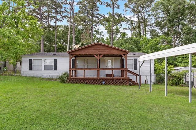 a view of a house with a yard and sitting area