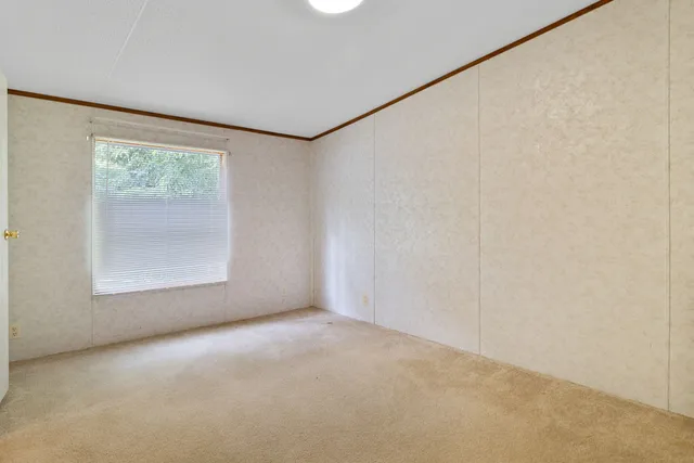 a view of an empty room with a ceiling fan