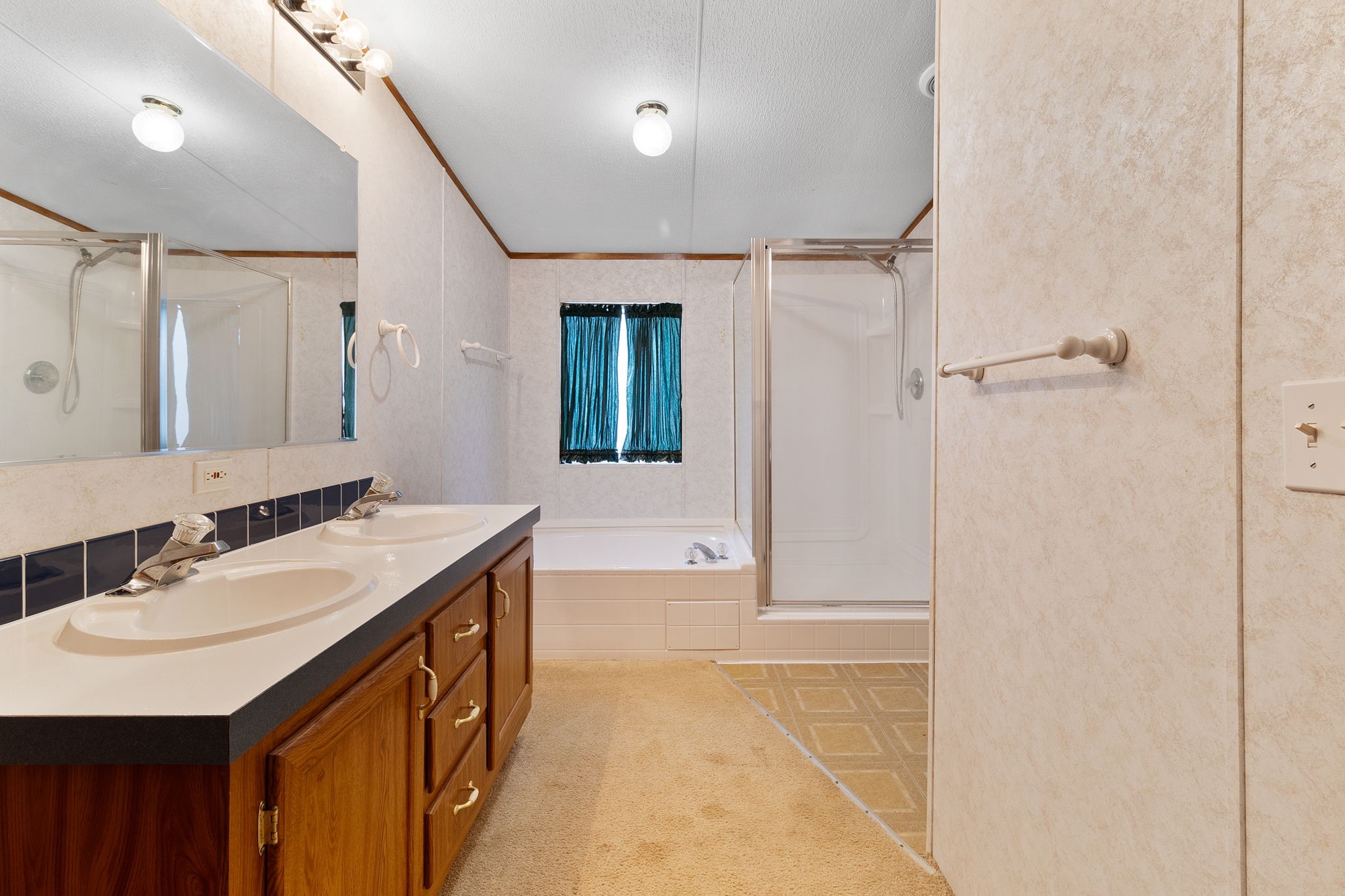 121 West Oak Shadows Onalaska, TX 77360 - Photo 15 of 20 a bathroom with a sink a mirror and a shower