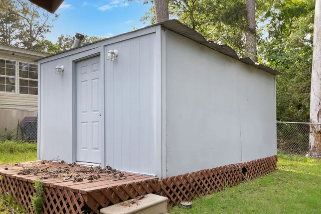 a view of a backyard with a large tree