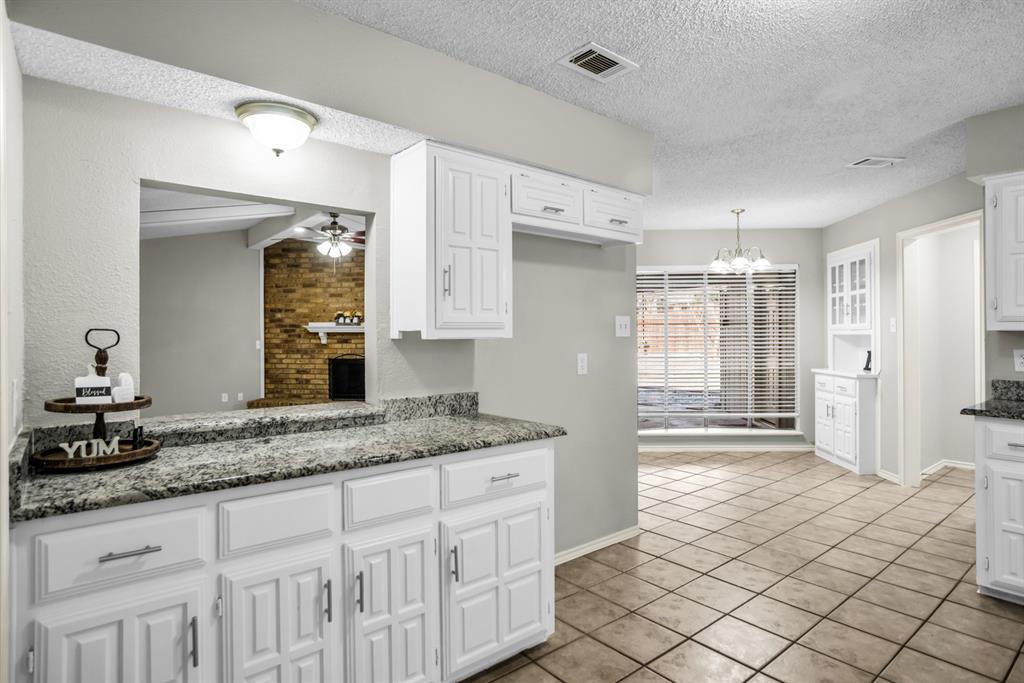 5902 Fawn Valley Lane Rowlett, TX 75089 - Photo 11 of 27 a spacious bathroom with a granite countertop sink mirror and shower