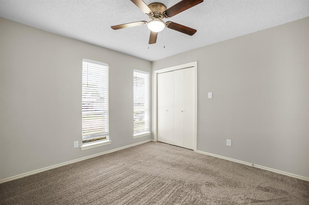5902 Fawn Valley Lane Rowlett, TX 75089 - Photo 15 of 27 an empty room with windows and ceiling fan