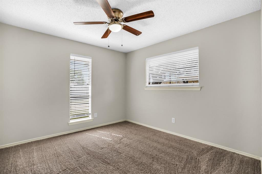 5902 Fawn Valley Lane Rowlett, TX 75089 - Photo 18 of 27 an empty room with windows and fan