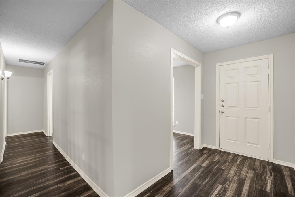5902 Fawn Valley Lane Rowlett, TX 75089 - Photo 2 of 27 a view of a hallway with wooden floor