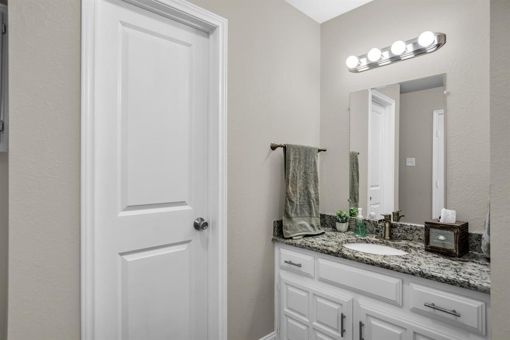 5902 Fawn Valley Lane Rowlett, TX 75089 - Photo 23 of 27 a bathroom with a sink and a mirror
