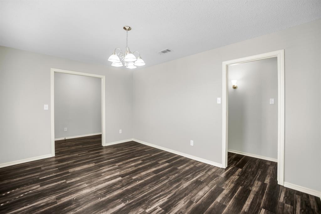 5902 Fawn Valley Lane Rowlett, TX 75089 - Photo 4 of 27 a view of a room with wooden floor and chandelier