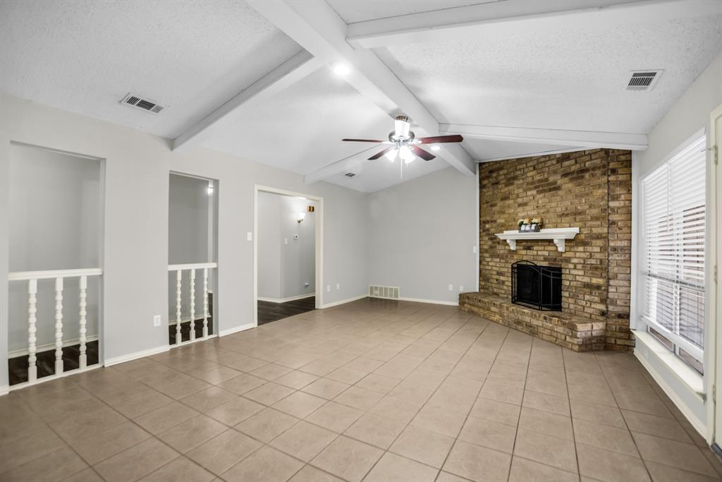 5902 Fawn Valley Lane Rowlett, TX 75089 - Photo 5 of 27 an empty room with windows and fireplace