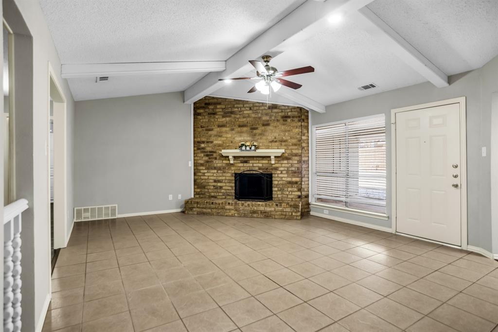 5902 Fawn Valley Lane Rowlett, TX 75089 - Photo 6 of 27 an empty room with windows and fireplace