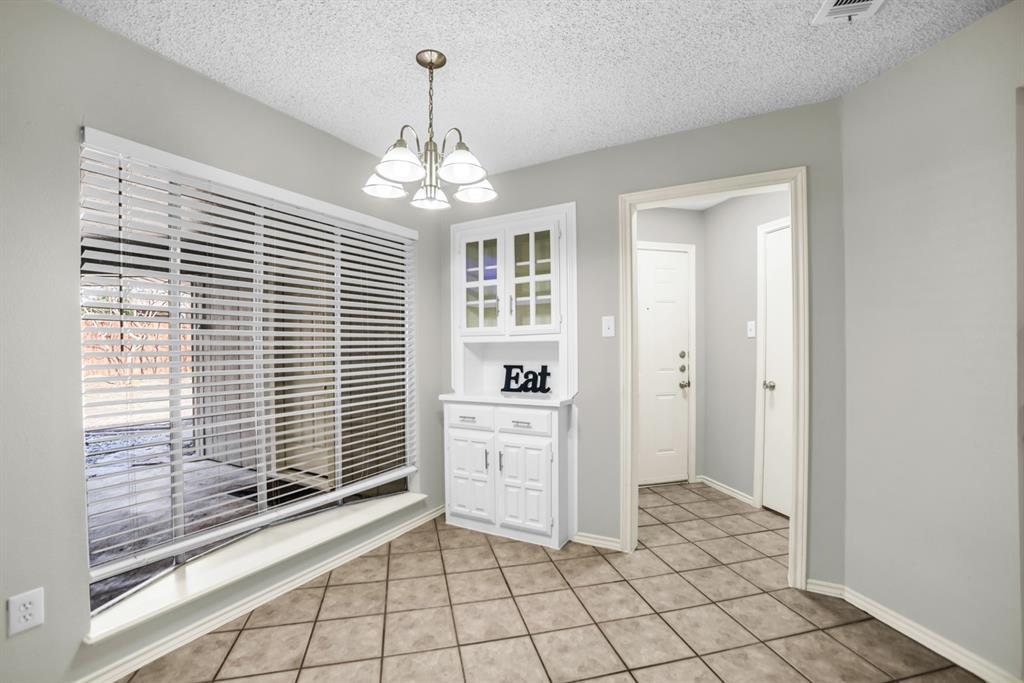 5902 Fawn Valley Lane Rowlett, TX 75089 - Photo 8 of 27 a view of a livingroom with a chandelier fan and windows