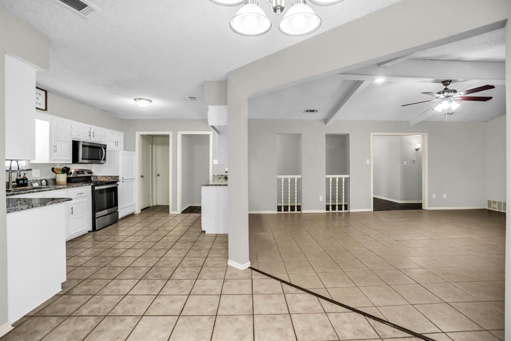 5902 Fawn Valley Lane Rowlett, TX 75089 - Photo 9 of 27 a view of a kitchen with microwave and refrigerator