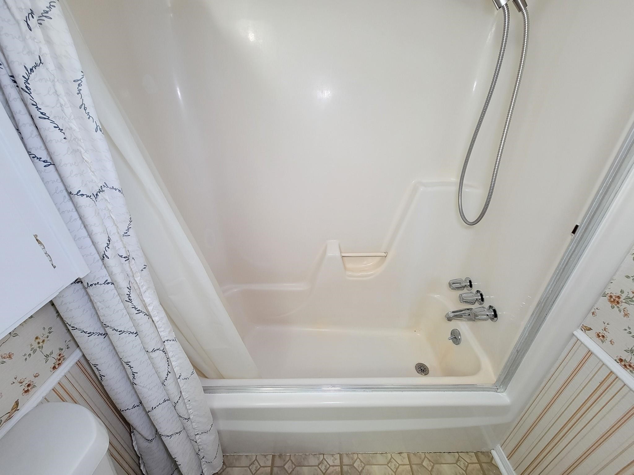 1815 Country Village Boulevard Humble, TX 77338 - Photo 11 of 34 a bathroom with a bathtub and shower