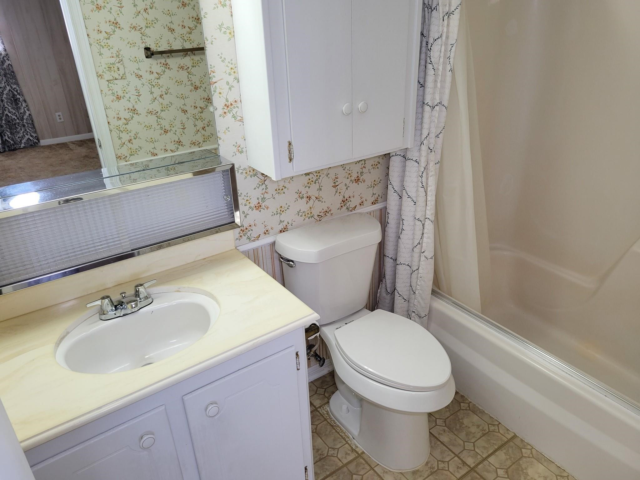 1815 Country Village Boulevard Humble, TX 77338 - Photo 12 of 34 a white toilet sitting next to a bathroom sink