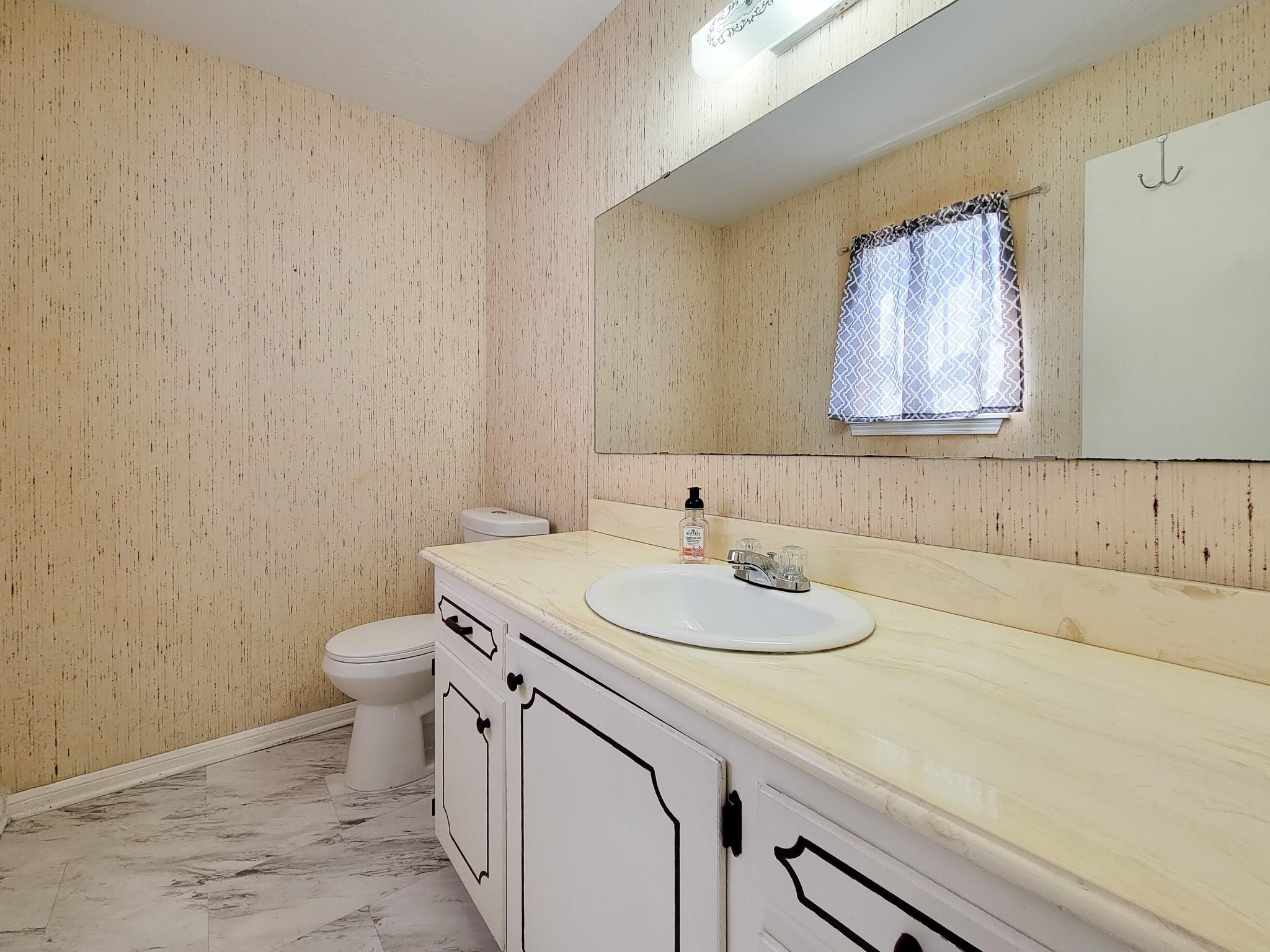 1815 Country Village Boulevard Humble, TX 77338 - Photo 14 of 34 a bathroom with a sink and a toilet
