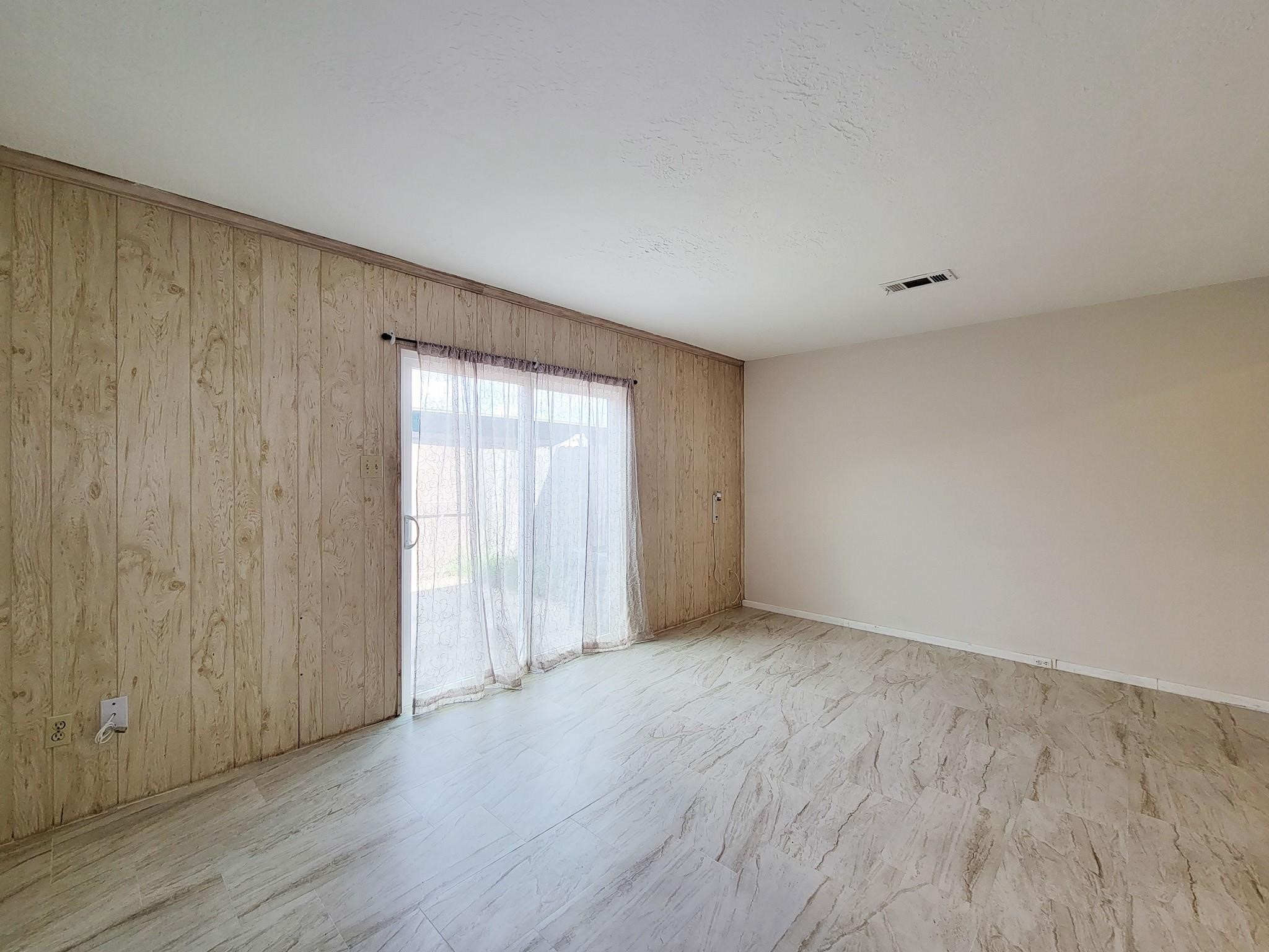1815 Country Village Boulevard Humble, TX 77338 - Photo 15 of 34 a view of an empty room with wooden floor and a window