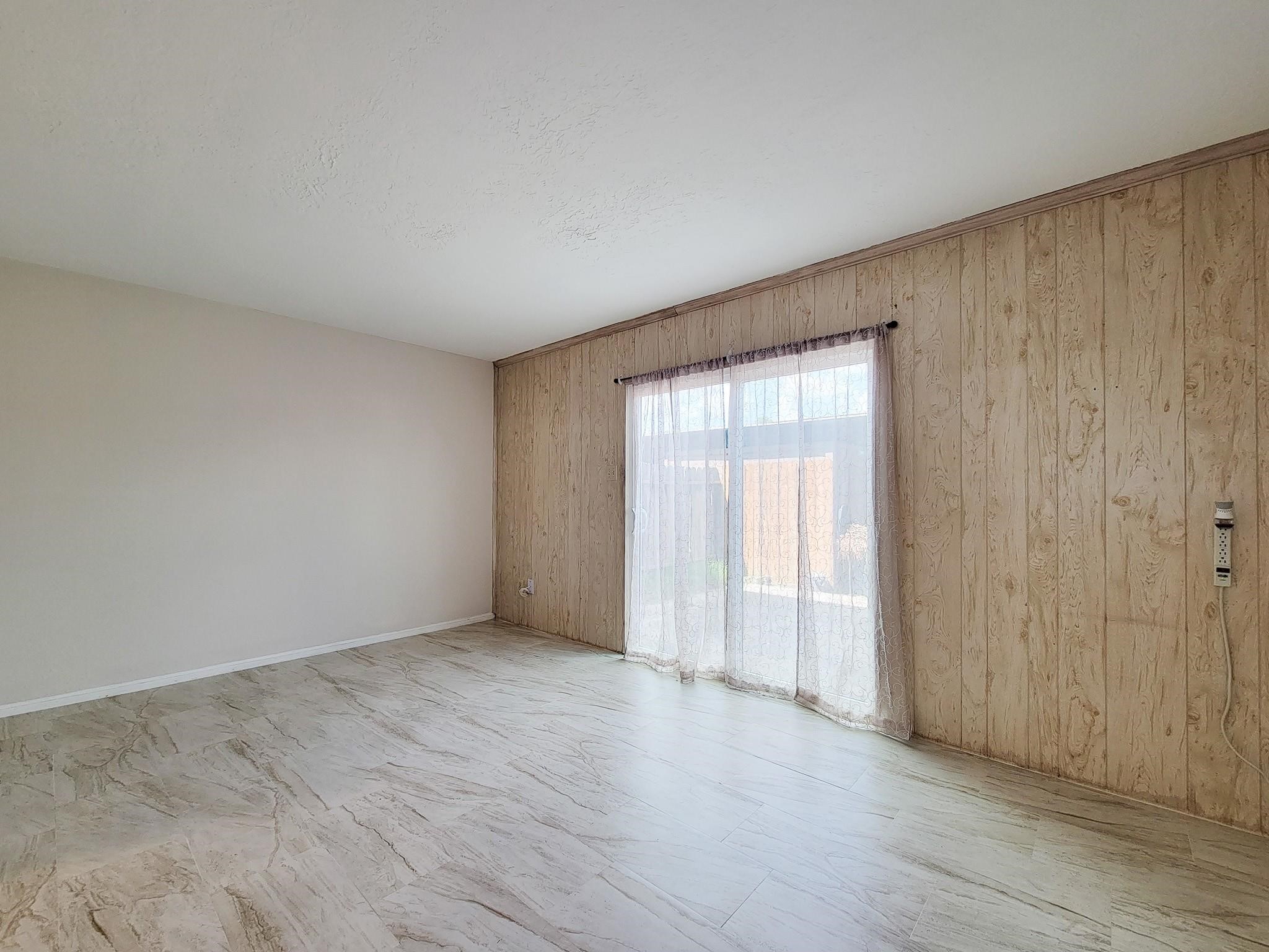 1815 Country Village Boulevard Humble, TX 77338 - Photo 18 of 34 an empty room with wooden floor and sliding door