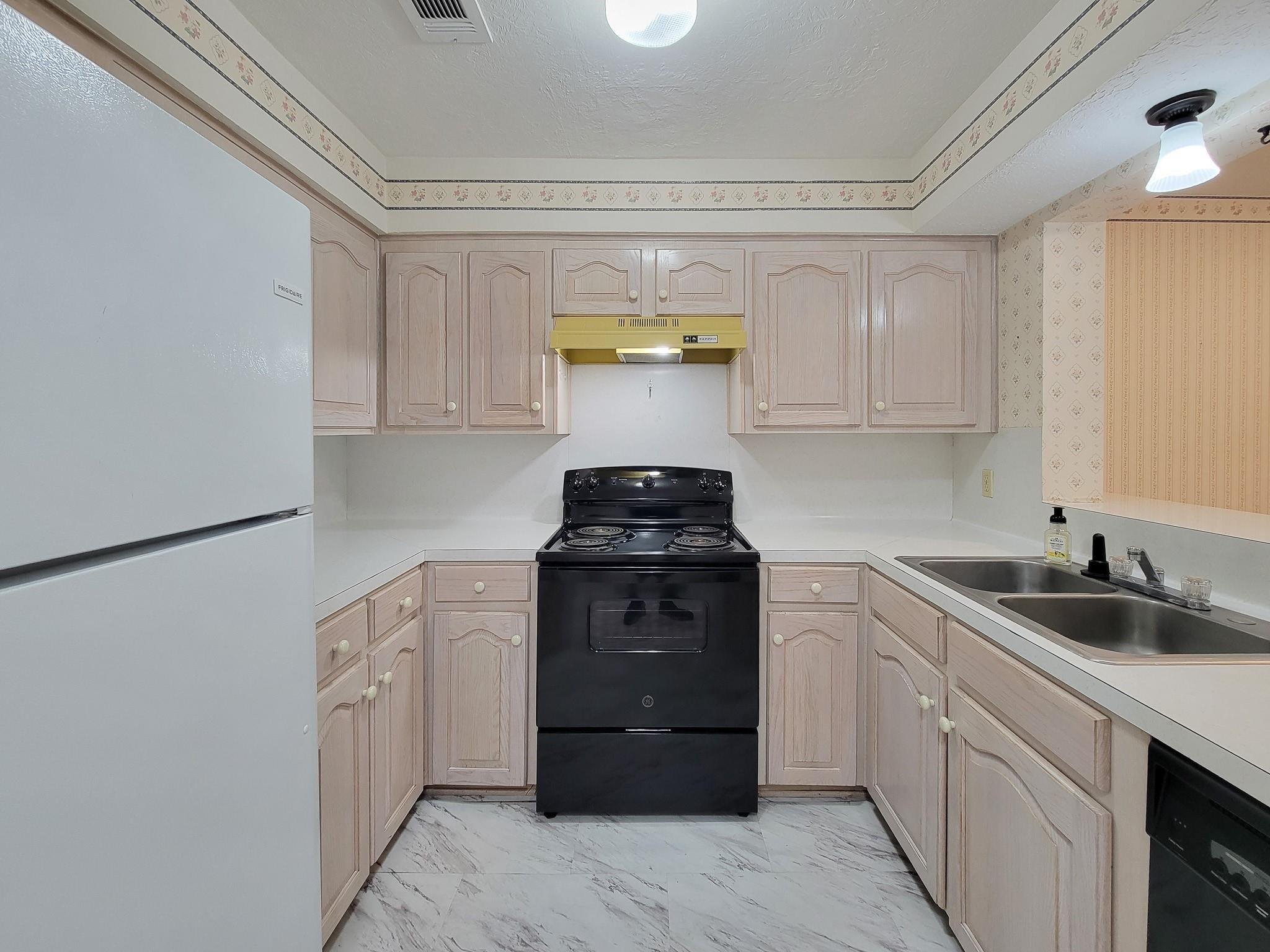 1815 Country Village Boulevard Humble, TX 77338 - Photo 33 of 34 a kitchen with a sink and cabinets