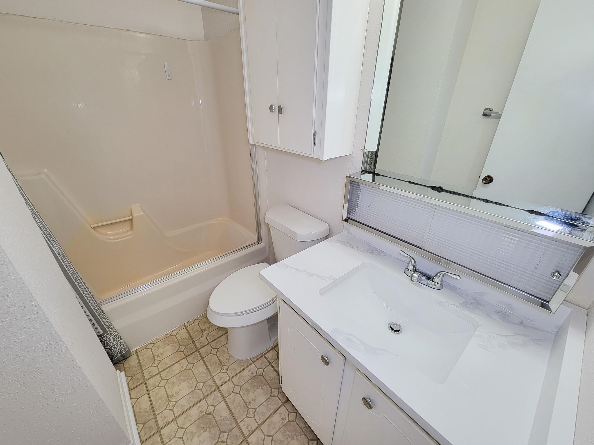 1815 Country Village Boulevard Humble, TX 77338 - Photo 9 of 34 a bathroom with a sink a toilet and shower