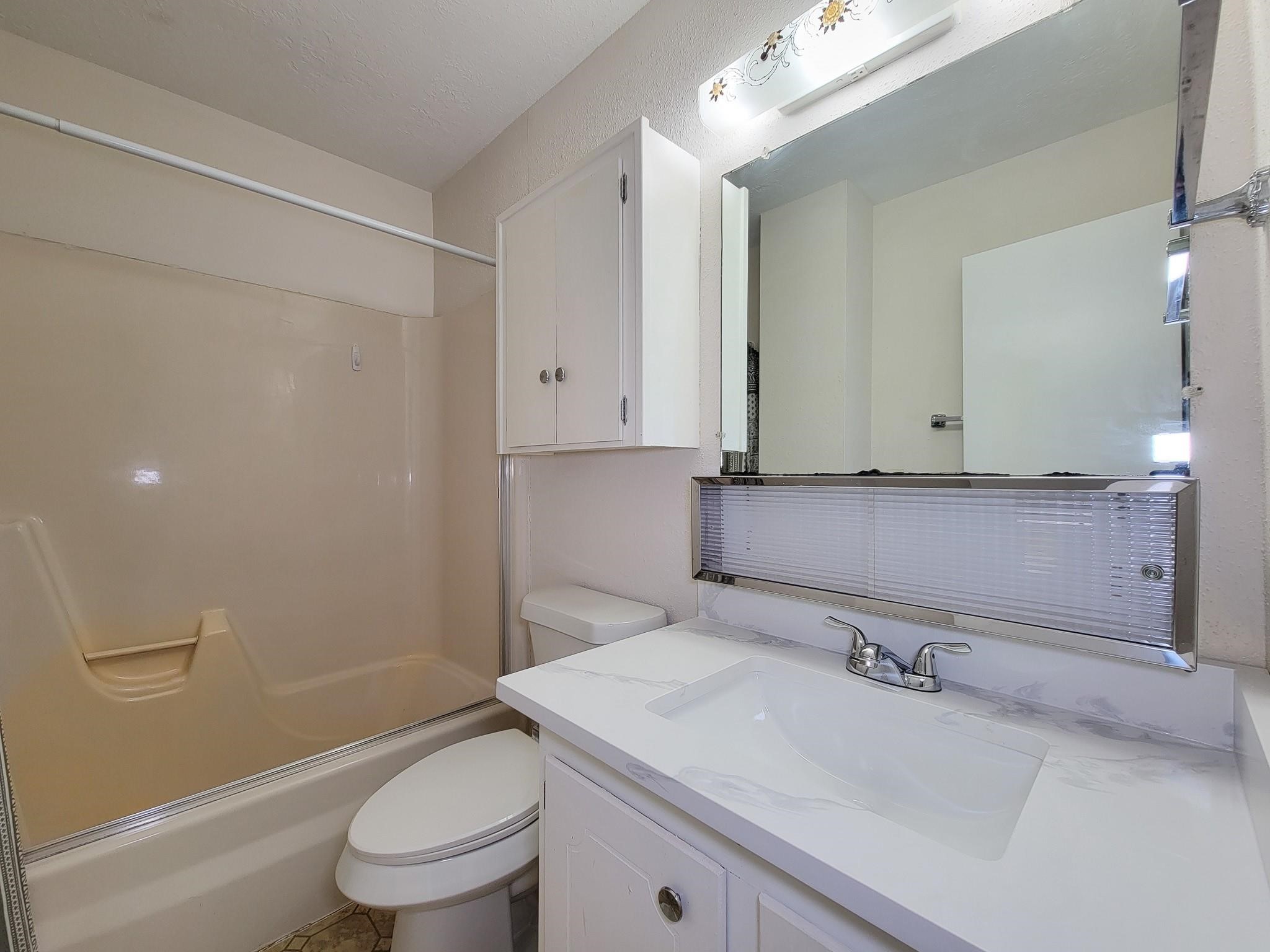 1815 Country Village Boulevard Humble, TX 77338 - Photo 10 of 34 a bathroom with a sink a toilet and shower