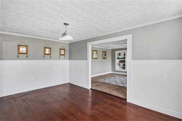 a view of livingroom with hardwood floor and kitchen view