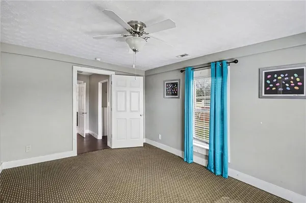 a view of a livingroom with a ceiling fan and window