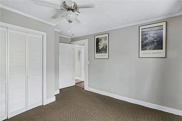 a view of a hallway with a chandelier fan