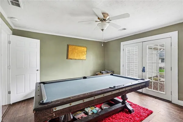 a room with furniture pool table and windows