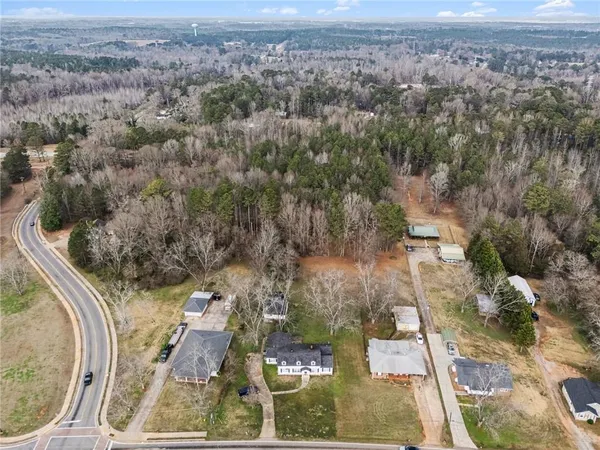 an aerial view of a house with a yard