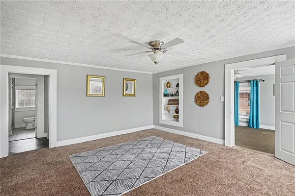 a view of an empty room and window and cabinet