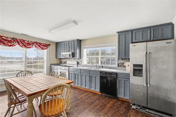 a kitchen with kitchen island a sink stove and refrigerator
