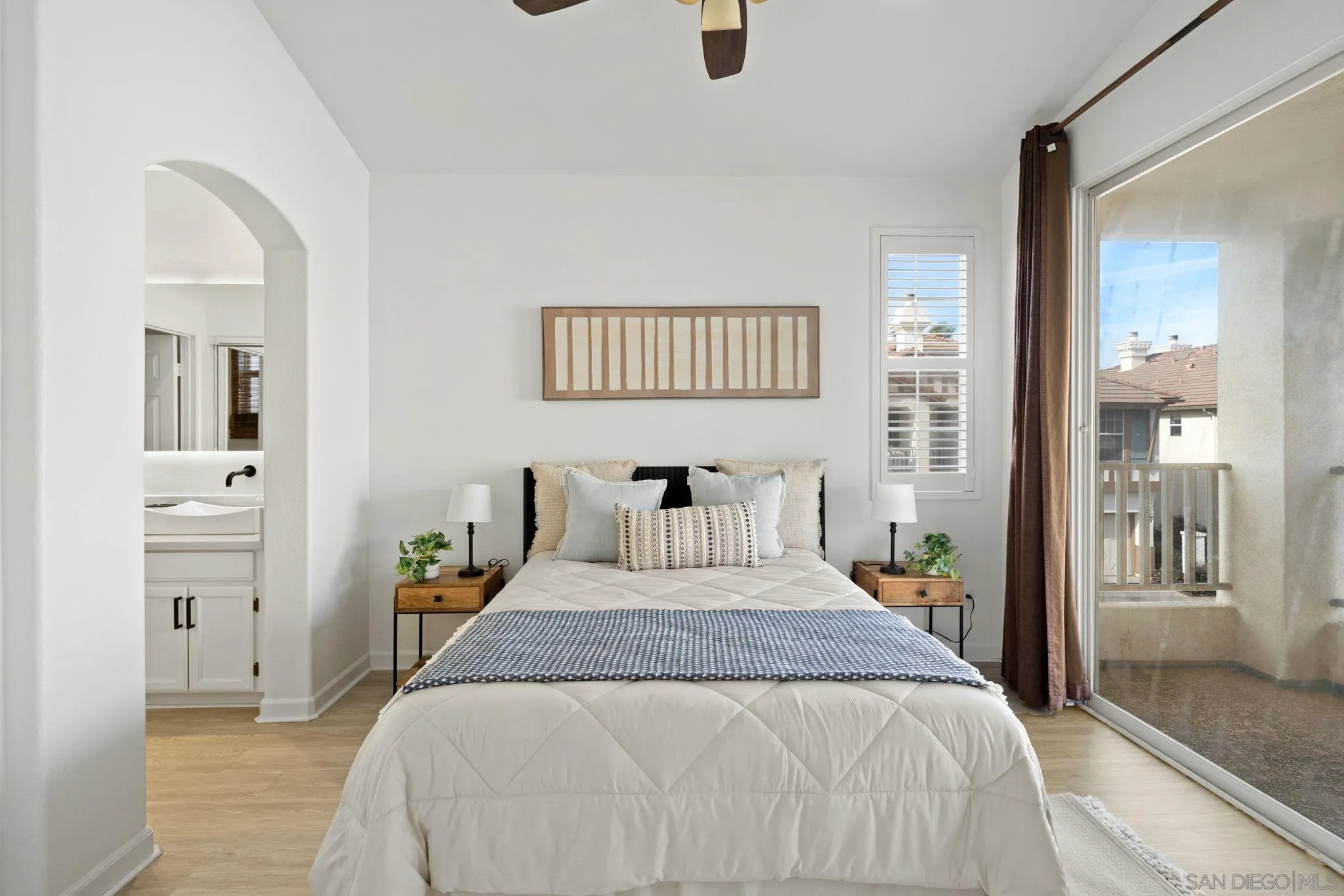 549 Sweet Pea Place Encinitas, CA 92024 - Photo 13 of 29 a bedroom with a bed and wooden floor