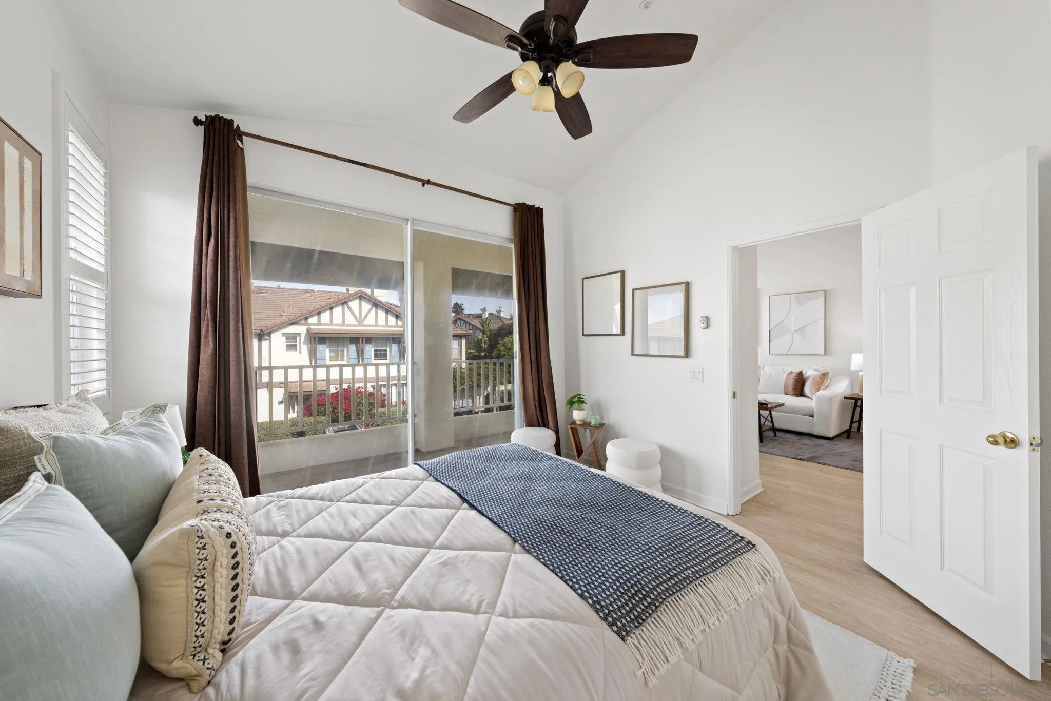 549 Sweet Pea Place Encinitas, CA 92024 - Photo 16 of 29 a bedroom with a bed couch and a large window