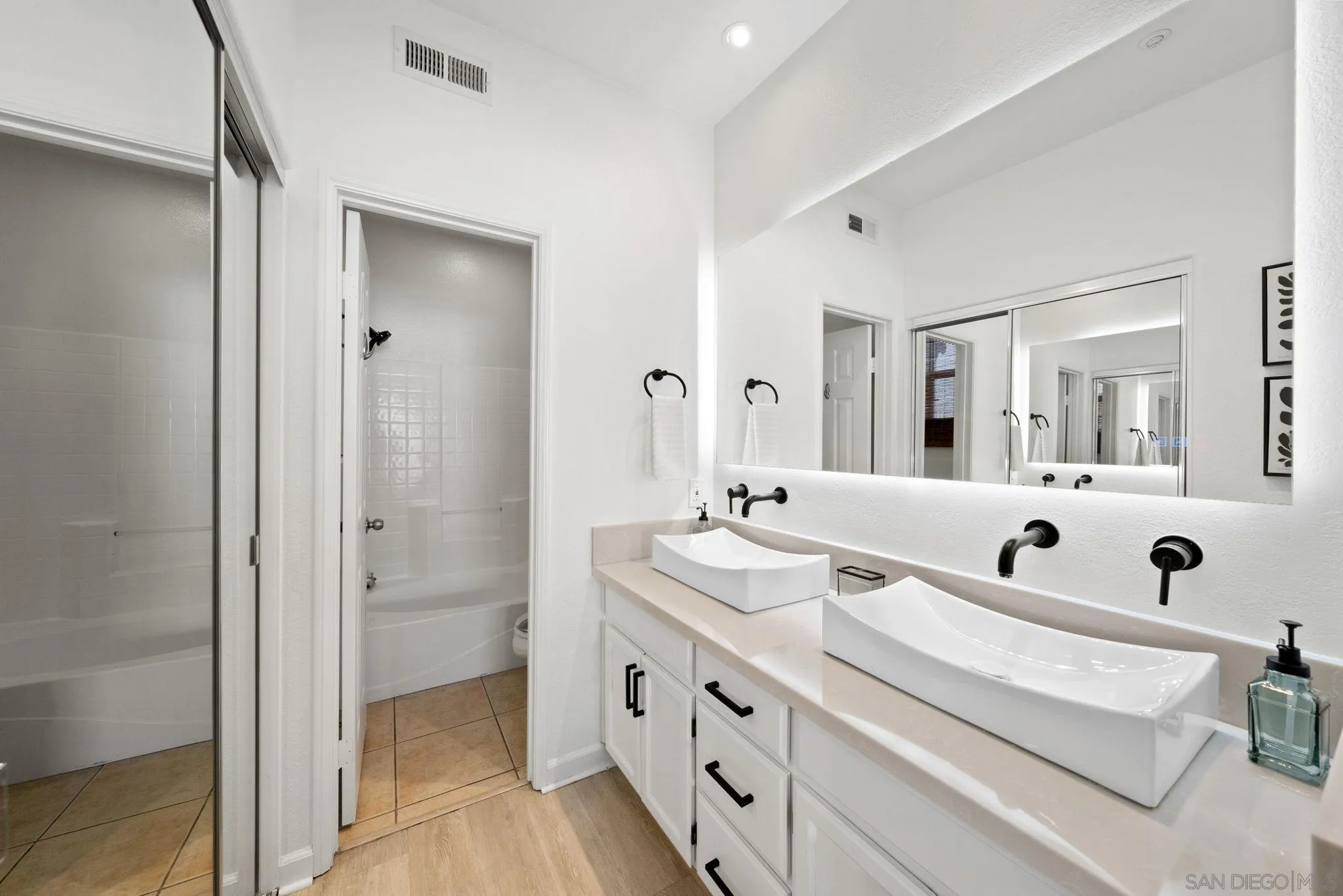 549 Sweet Pea Place Encinitas, CA 92024 - Photo 17 of 29 a bathroom with double vanity sinks and a mirror