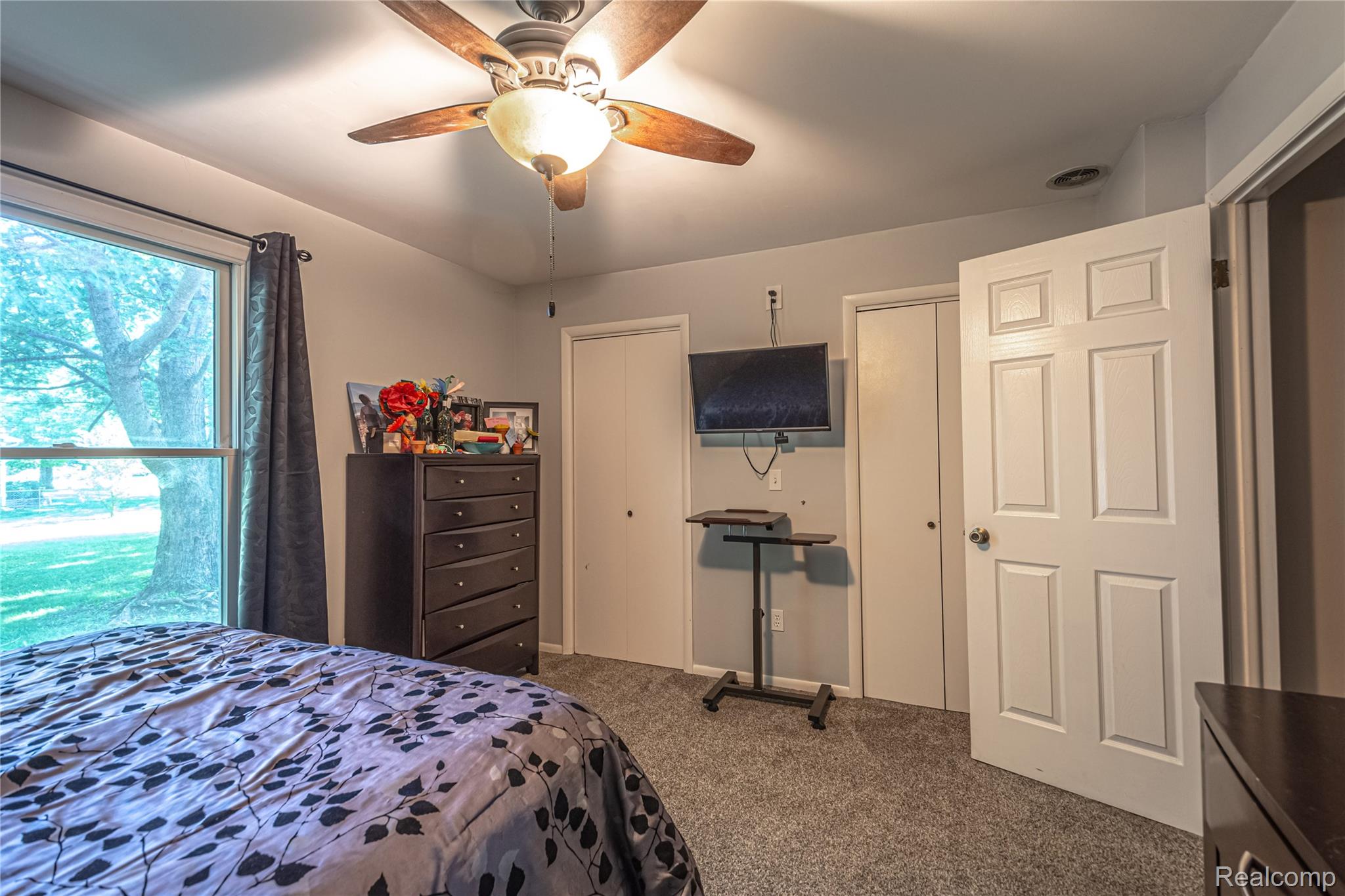 3241 Simpson Road Fort Gratiot, MI 48059 - Photo 27 of 27 Carpeted room with a large window, a ceiling fan with integrated lighting, and two panel doors