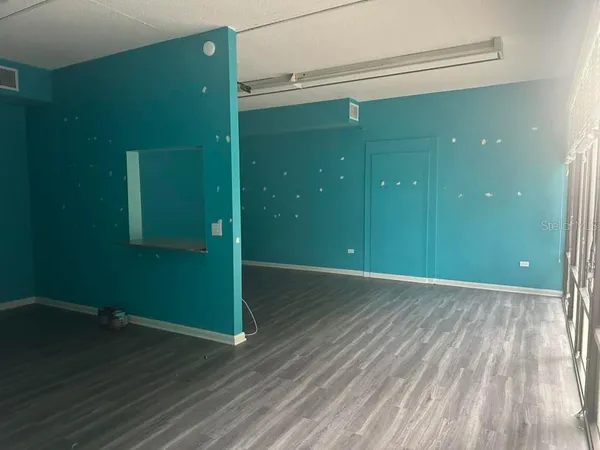 a view of a room with wooden floor