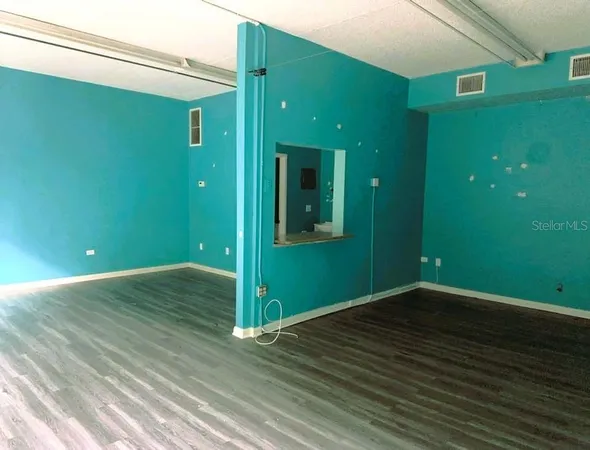 a view of a room with wooden floor