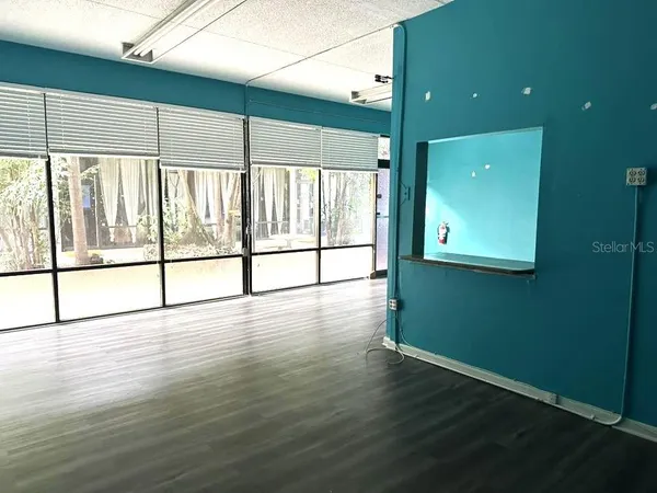 a view of a room with wooden floor and windows
