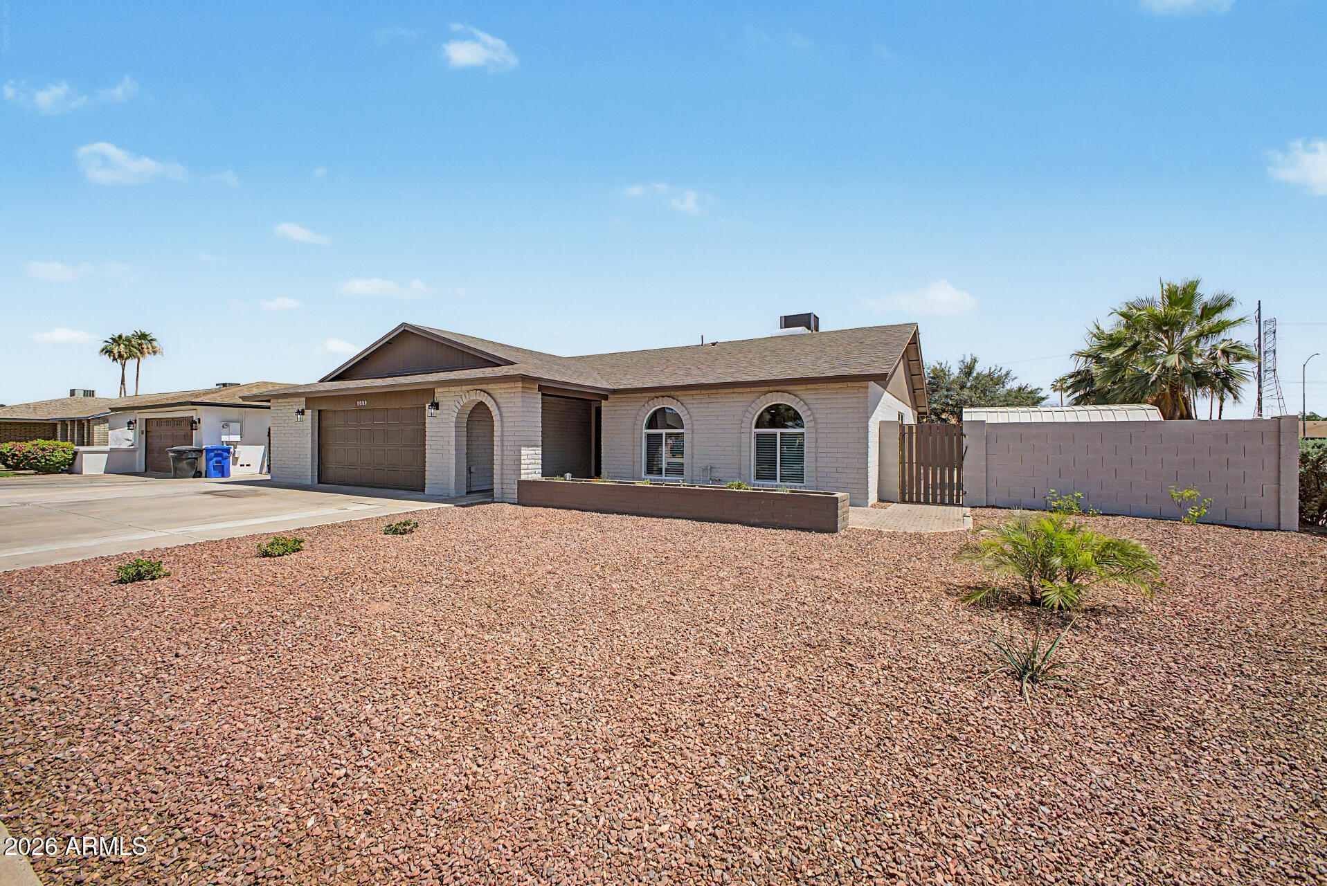 1009 West Pampa Avenue Mesa, AZ 85210 - Photo 2 of 31 a front view of a house with a yard and a garage