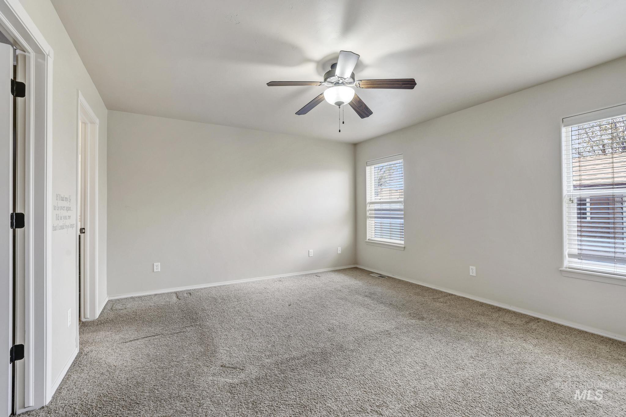 446 Noble Street Twin Falls, ID 83301 - Photo 18 of 42 Spacious room with light gray carpeting and light-colored walls