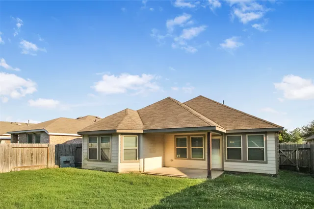 a view of a house with a yard and plants