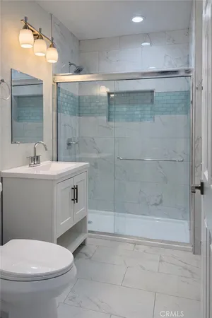 a bathroom with a sink toilet and shower