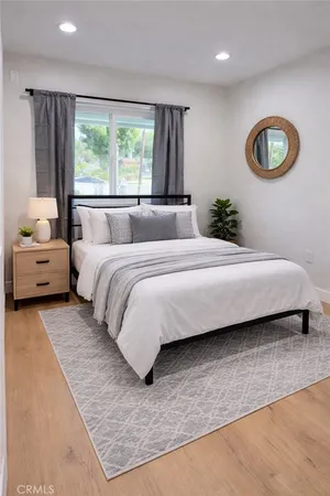 a bedroom with a bed and window