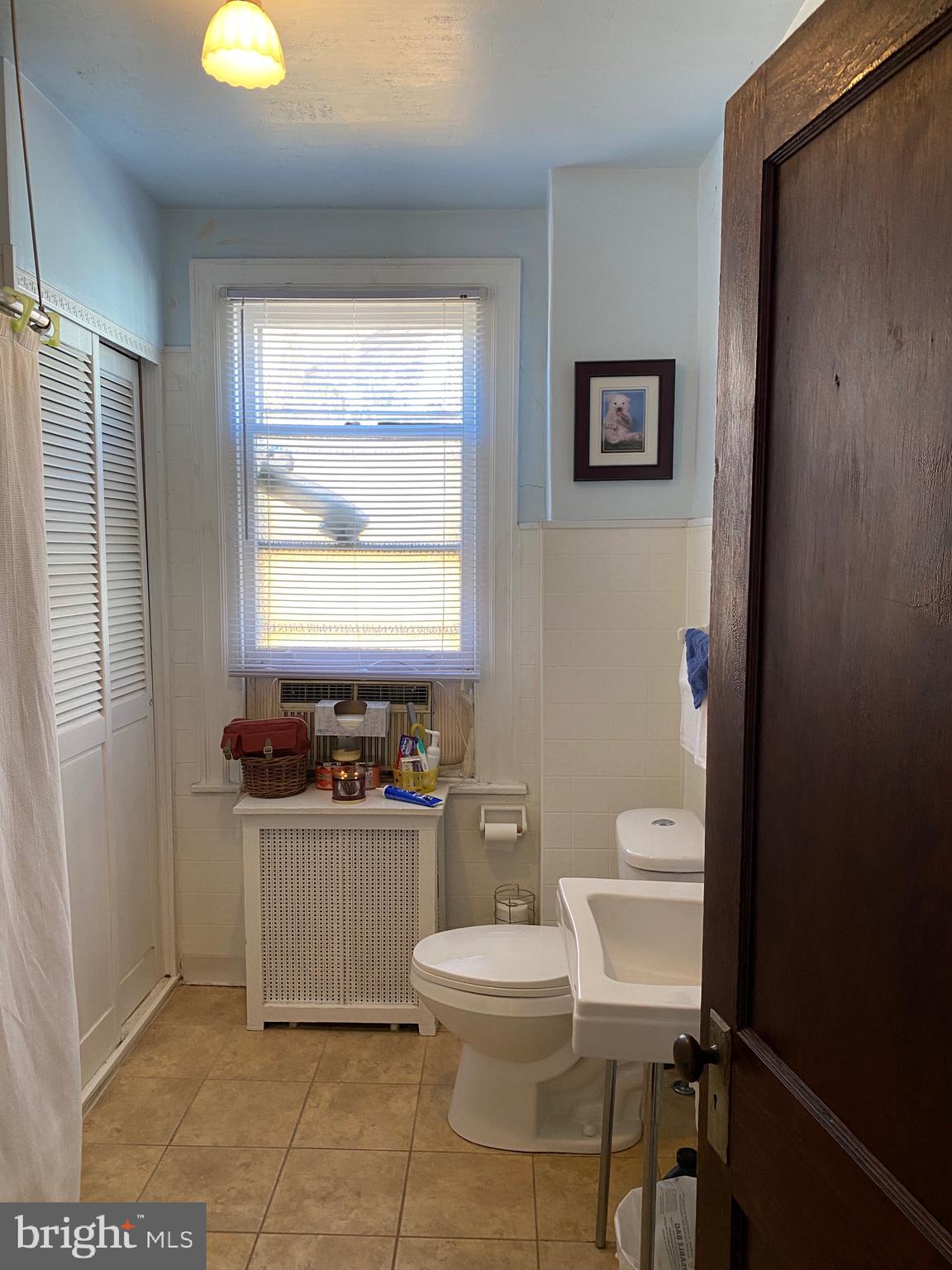 813 Levick Street Philadelphia, PA 19111 - Photo 26 of 43 a bathroom with a toilet a sink and a window