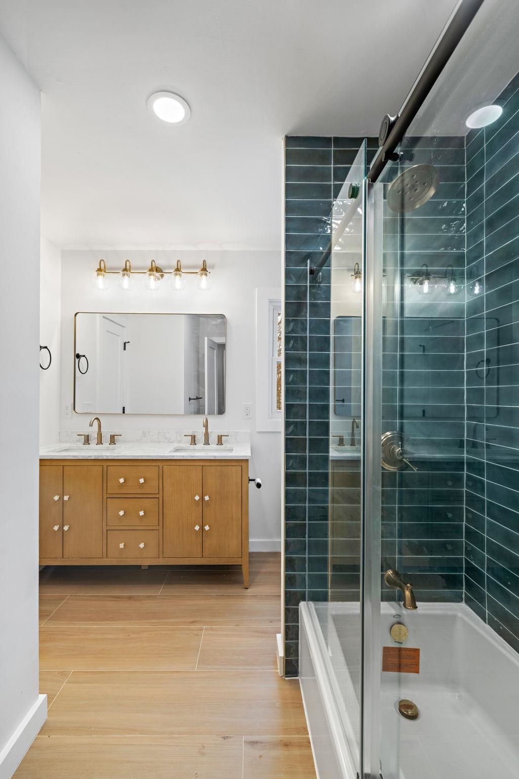 125 Rutgers Place Clifton, NJ 07013 - Photo 26 of 36 a bathroom with a tub a sink a mirror and shower