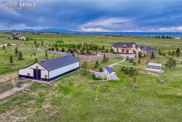 an aerial view of a house with garden space and outdoor seating