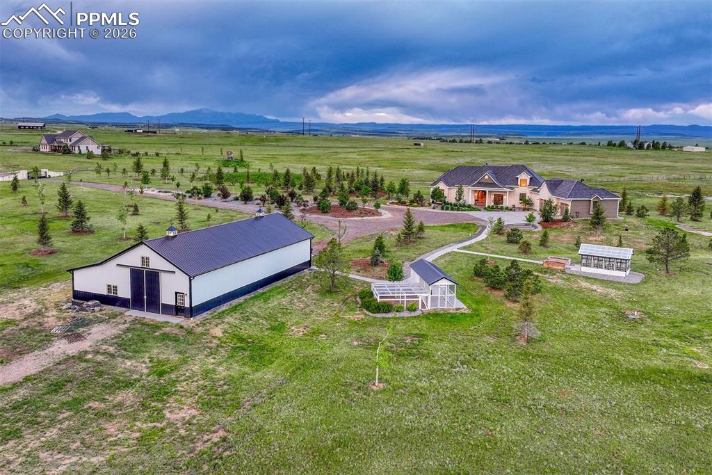 an aerial view of a house with garden space and outdoor seating